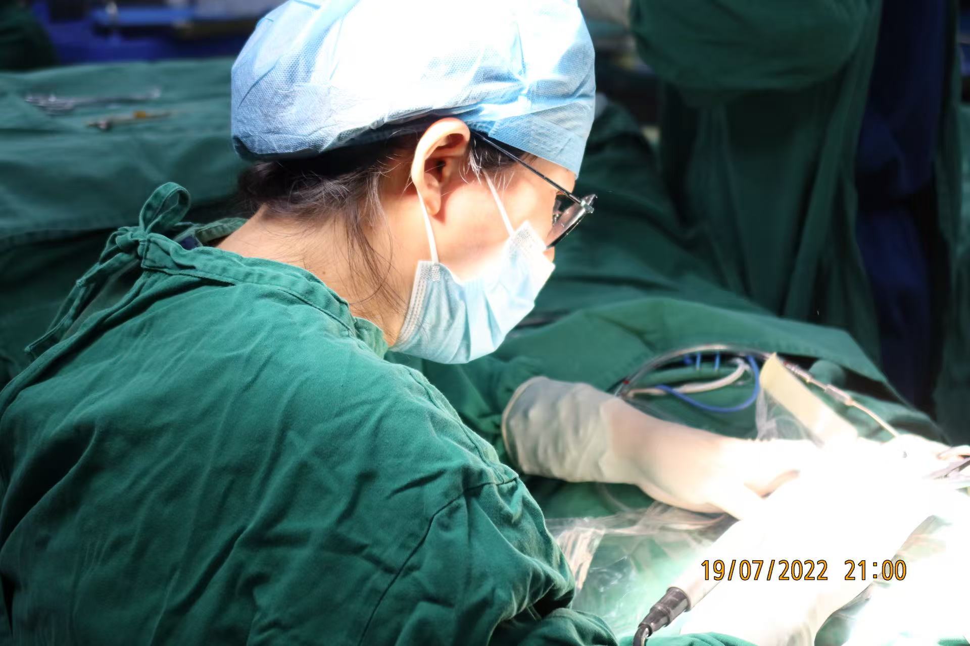 Dr. Tang performing an otologic procedure in the operating room